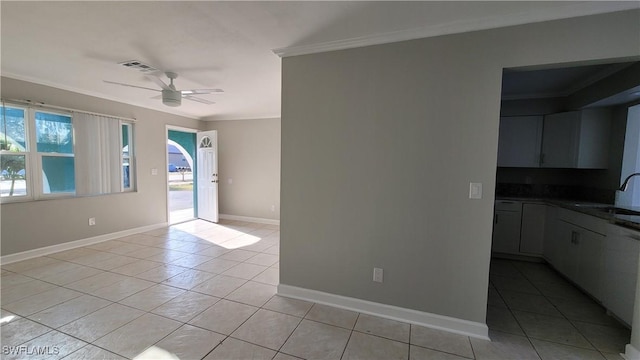 interior space featuring light tile patterned floors, ceiling fan, crown molding, and sink