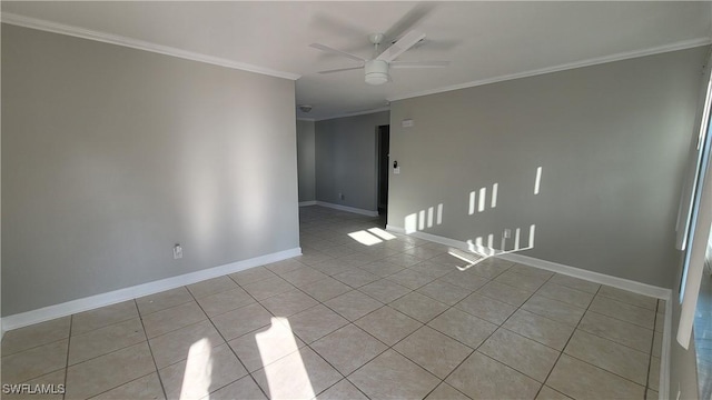 tiled spare room featuring ceiling fan and ornamental molding