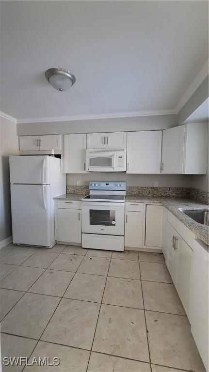 kitchen featuring white cabinets, white appliances, sink, and light tile patterned floors