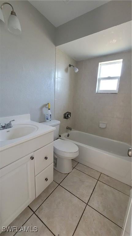 full bathroom featuring tile patterned flooring, tiled shower / bath combo, toilet, and vanity