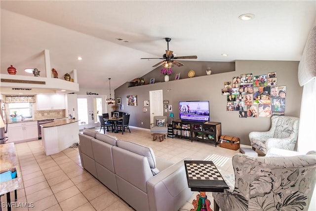 living room featuring ceiling fan, light tile patterned floors, and vaulted ceiling