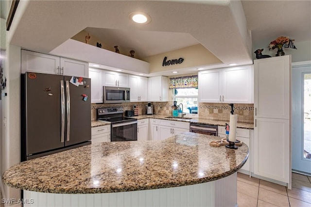 kitchen with sink, decorative backsplash, light stone countertops, white cabinetry, and stainless steel appliances