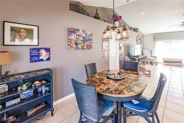 dining area featuring vaulted ceiling, ceiling fan, and light tile patterned flooring