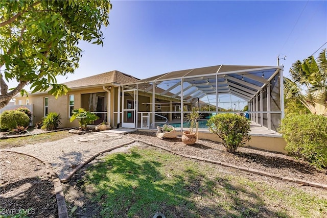 rear view of house featuring a lanai