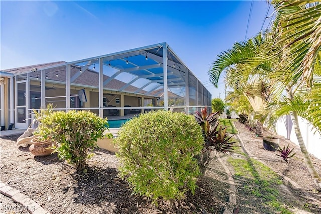 rear view of house featuring a lanai