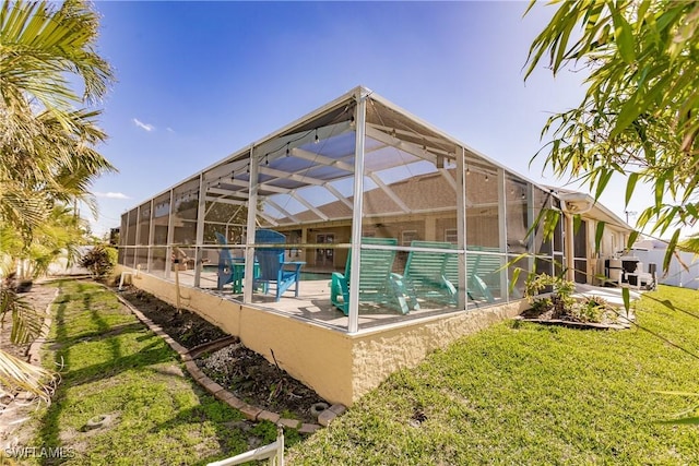 view of swimming pool featuring a lanai, a patio area, and a lawn