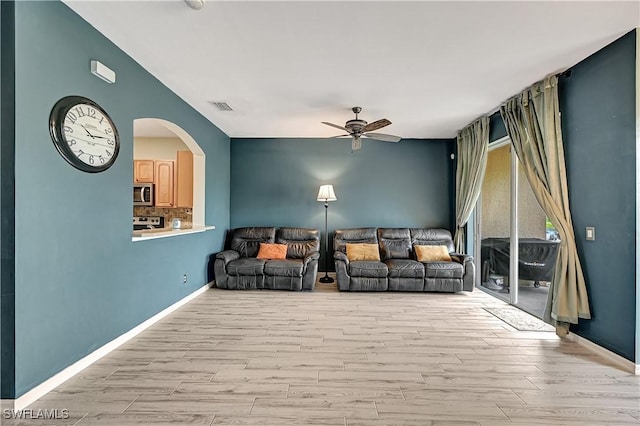 unfurnished living room with light wood-type flooring and ceiling fan