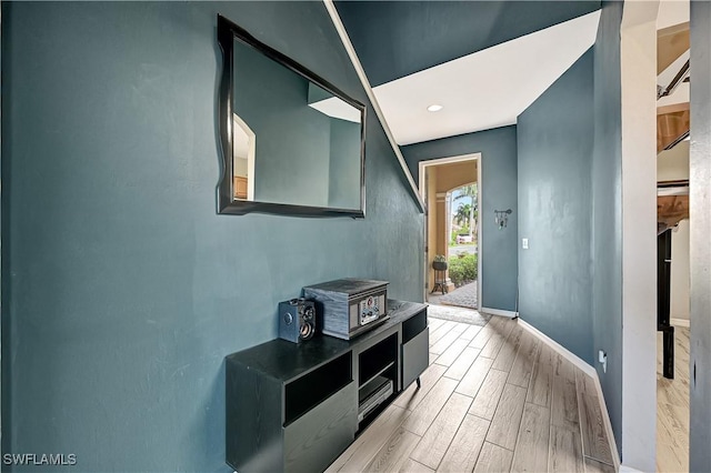 hallway with light hardwood / wood-style flooring