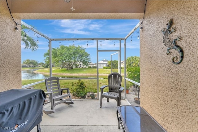 view of patio with a water view and area for grilling