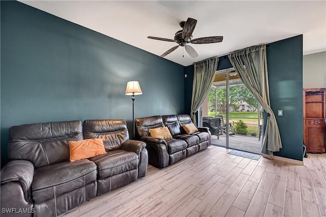 living room featuring light hardwood / wood-style flooring and ceiling fan