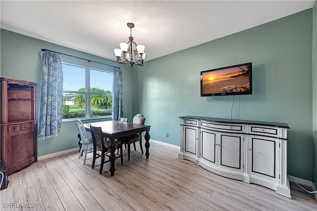 dining room with a notable chandelier and light wood-type flooring