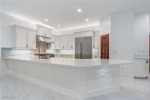 1160 8th St S, Naples, FL 34102 - kitchen featuring under cabinet range hood, marble finish floor, built in fridge, and a sink
