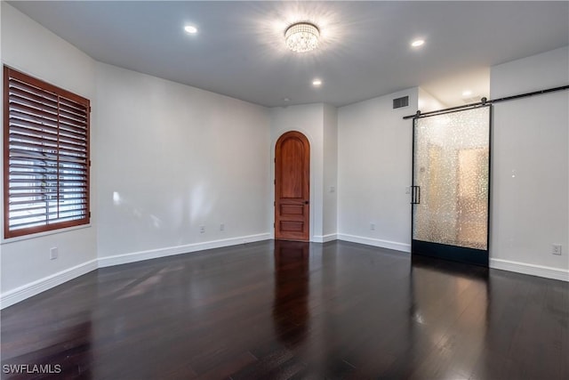 1160 8th St S, Naples, FL 34102 - empty room featuring visible vents, baseboards, recessed lighting, wood finished floors, and arched walkways