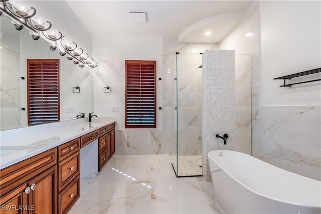 1160 8th St S, Naples, FL 34102 - full bathroom with a marble finish shower, double vanity, a freestanding tub, marble finish floor, and tile walls