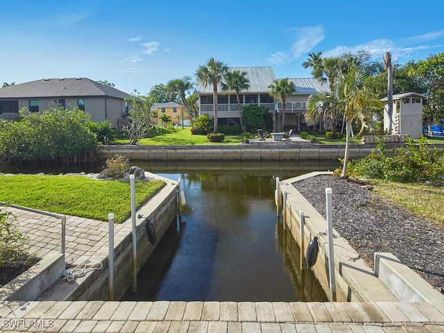 dock area featuring a water view and a lawn