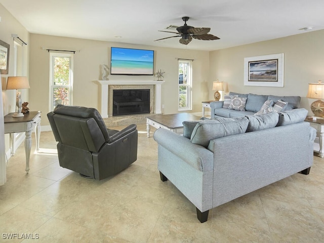 living room featuring ceiling fan, light tile patterned floors, and a wealth of natural light