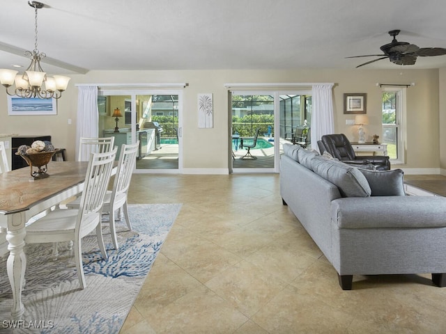 living room with ceiling fan with notable chandelier