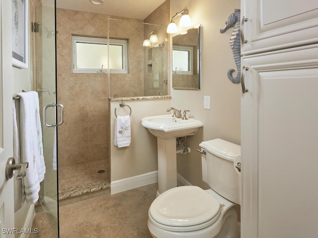 bathroom featuring sink, tile patterned flooring, toilet, and walk in shower