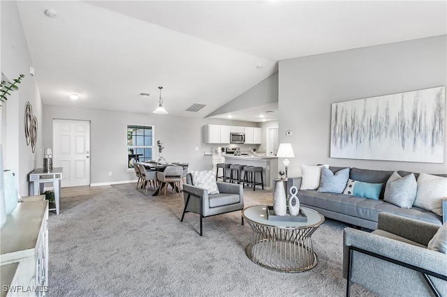 carpeted living room featuring lofted ceiling