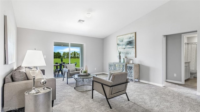 carpeted living room with lofted ceiling