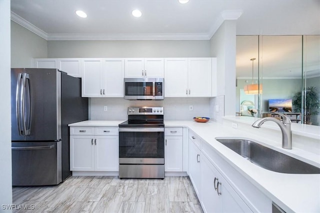 kitchen featuring white cabinets, stainless steel appliances, tasteful backsplash, and sink