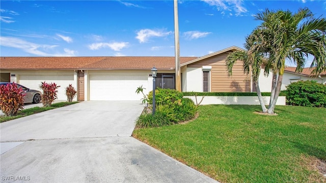 ranch-style home with a garage and a front yard