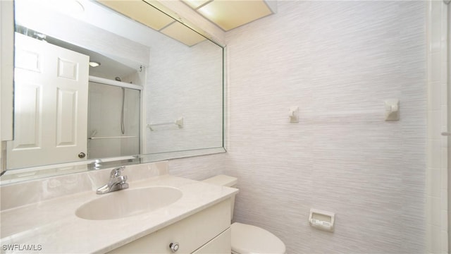 bathroom with vanity, an enclosed shower, and toilet