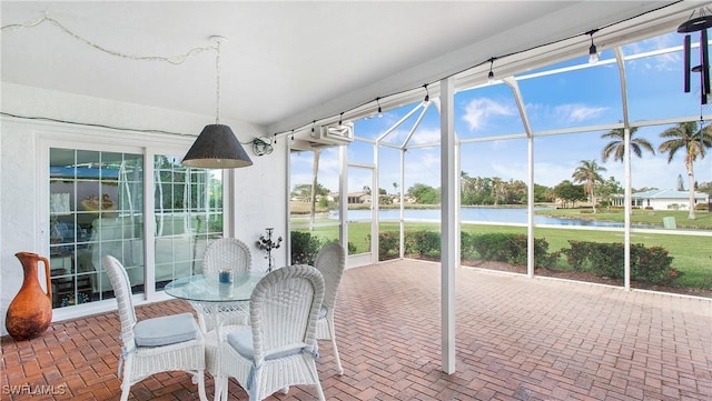 sunroom / solarium with a water view