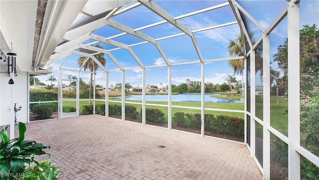 unfurnished sunroom with a water view