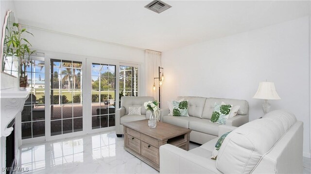 living area featuring marble finish floor and visible vents