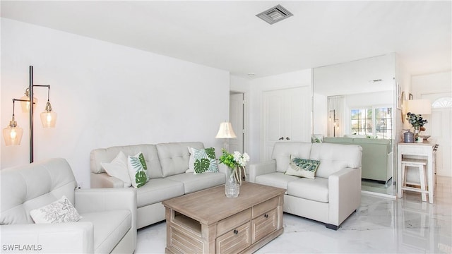 living room with marble finish floor and visible vents