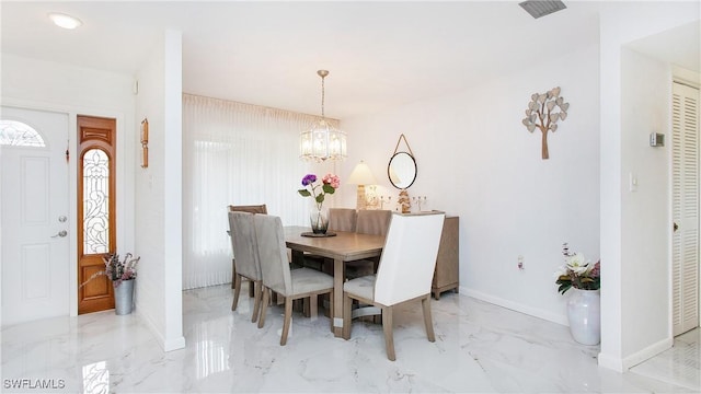 dining area with marble finish floor, baseboards, and a chandelier