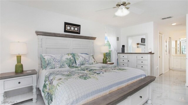 bedroom featuring ensuite bath, ceiling fan, and a closet