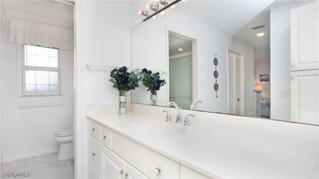 bathroom featuring vanity and toilet