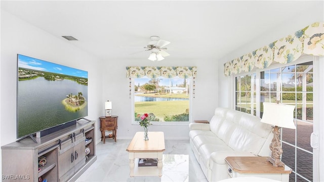 living room featuring marble finish floor, visible vents, plenty of natural light, and ceiling fan