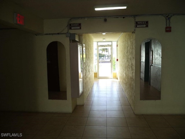 hallway featuring tile patterned flooring