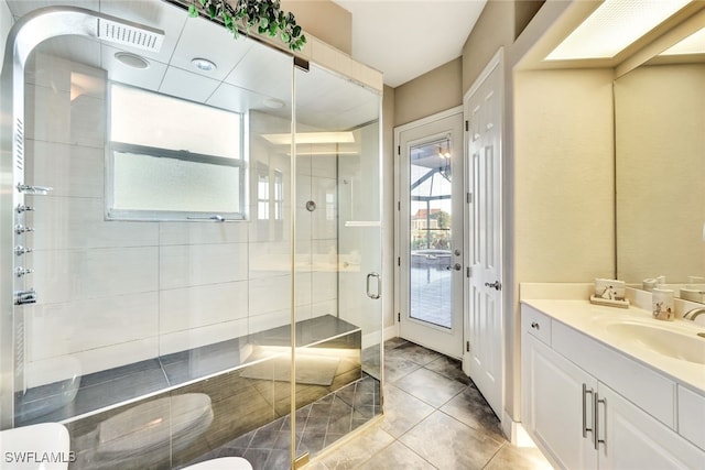 bathroom featuring an enclosed shower, vanity, toilet, and tile patterned flooring