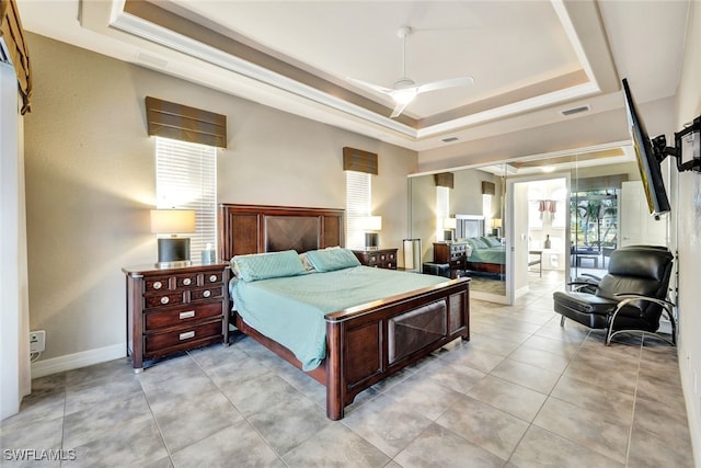 bedroom featuring ceiling fan and a tray ceiling