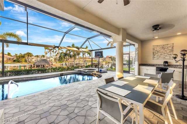 view of swimming pool featuring glass enclosure, area for grilling, an in ground hot tub, and a patio