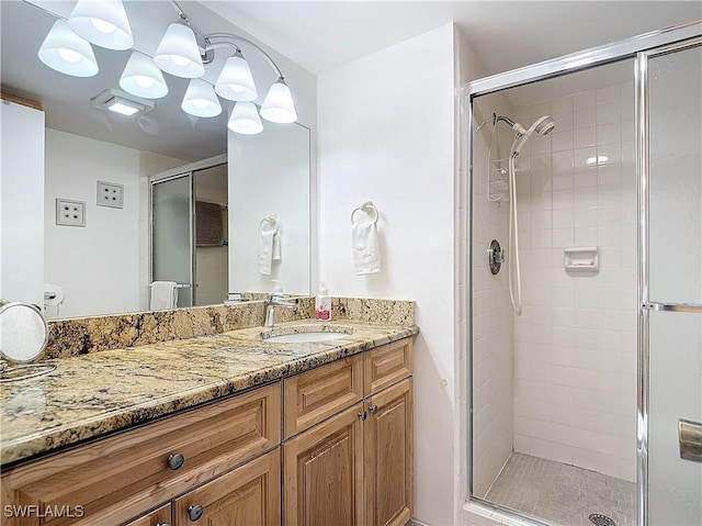 bathroom featuring vanity and a shower stall