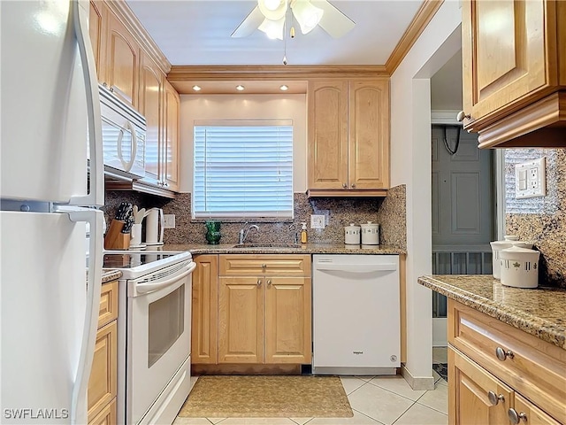 kitchen featuring light brown cabinets, a sink, tasteful backsplash, white appliances, and light stone countertops