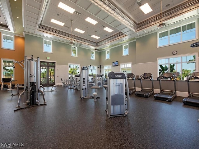 workout area featuring a high ceiling, french doors, ceiling fan, and ornamental molding