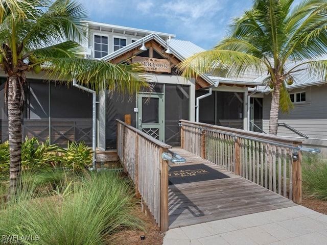 view of front of house featuring a sunroom and a deck