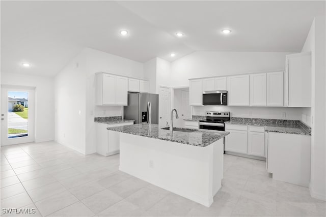 kitchen with lofted ceiling, white cabinets, sink, an island with sink, and appliances with stainless steel finishes