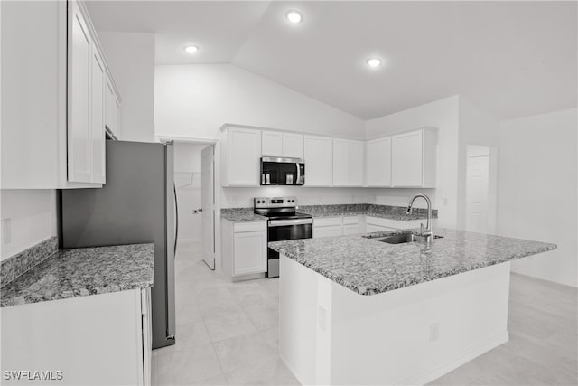 kitchen with appliances with stainless steel finishes, white cabinetry, lofted ceiling, and sink