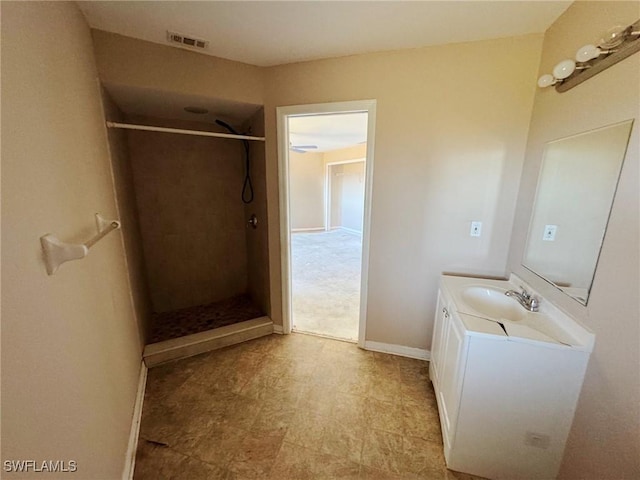 bathroom featuring vanity and a shower