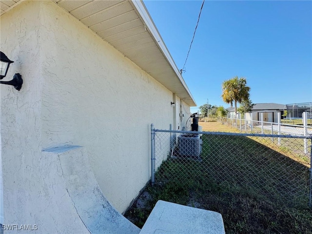 view of side of home with central AC unit