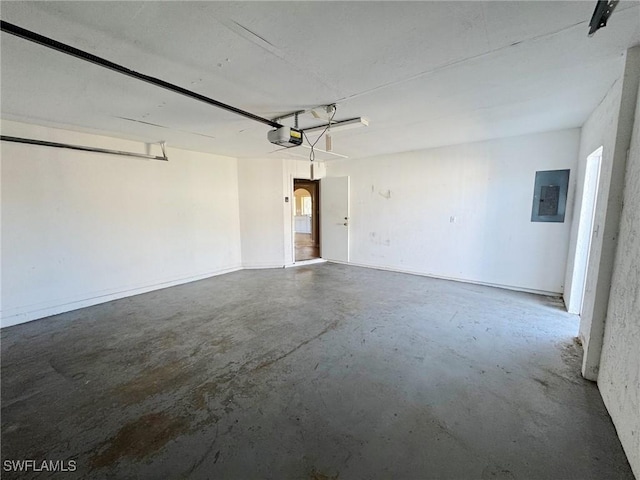 garage featuring electric panel and a garage door opener