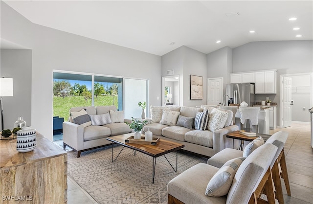 tiled living room with high vaulted ceiling