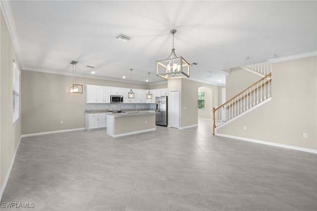 kitchen featuring white cabinetry, stainless steel appliances, crown molding, decorative light fixtures, and a kitchen island with sink